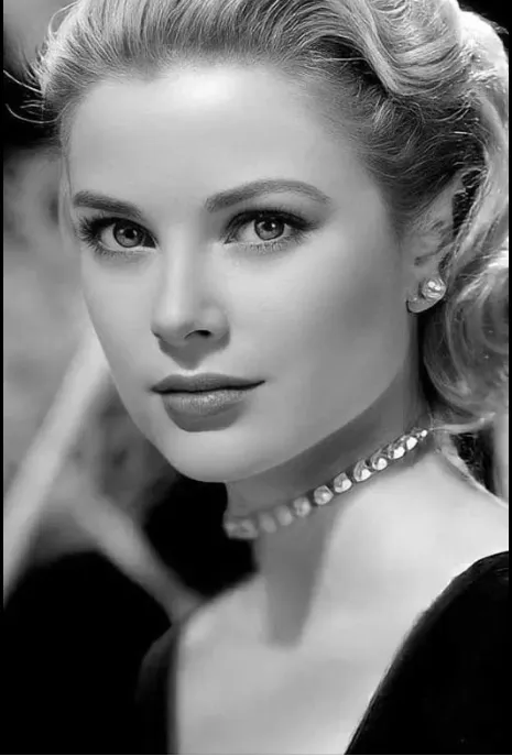 grace kelly wearing a black dress and pearls