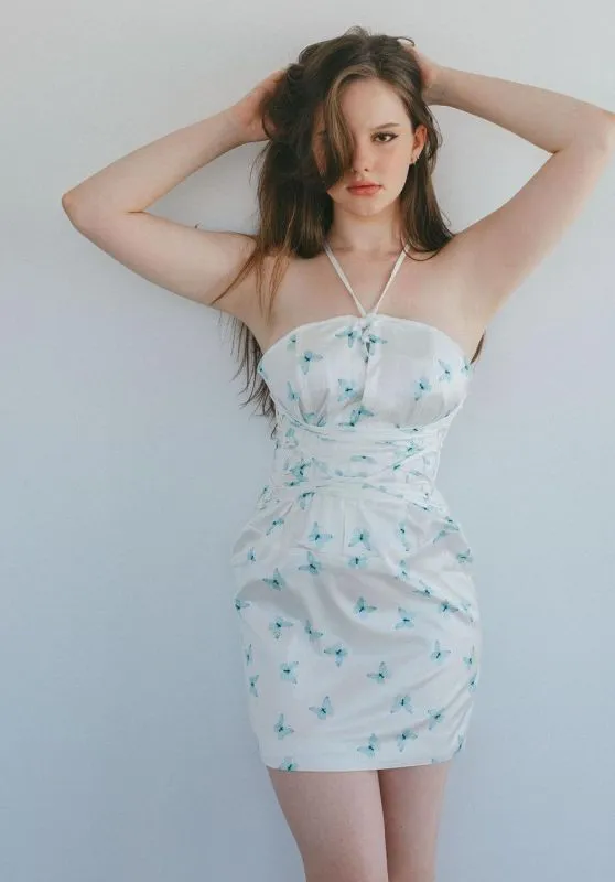 Isabella Ardley wearing a blue dress and looking playful